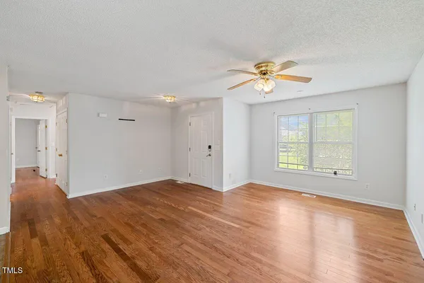 a view of a room with a window and a ceiling fan