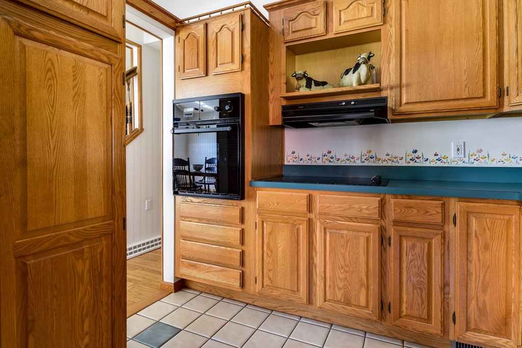 5 Rosenfeld Road Millis, MA 02054 - Photo 8 of 23 a kitchen with stainless steel appliances granite countertop a refrigerator and cabinets