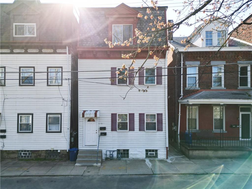 1509 Hatteras Street Pittsburgh, PA 15212 - Photo 1 of 28 a front view of residential houses with yard