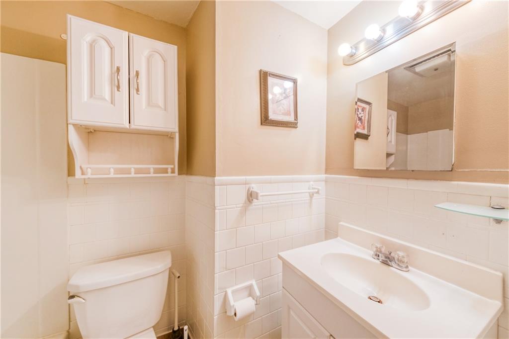1509 Hatteras Street Pittsburgh, PA 15212 - Photo 11 of 28 a bathroom with a sink a toilet and mirror