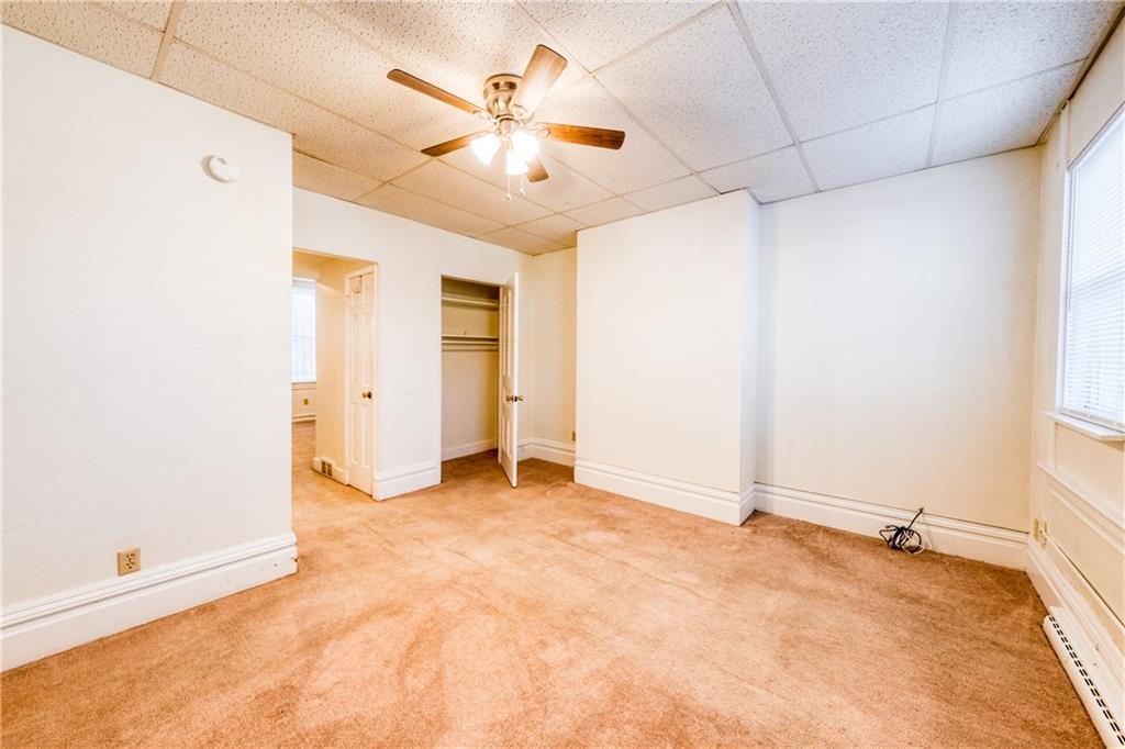 1509 Hatteras Street Pittsburgh, PA 15212 - Photo 10 of 28 an empty room with chandelier fan and windows