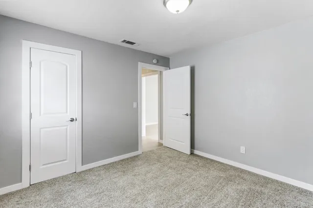 an empty room with closet area