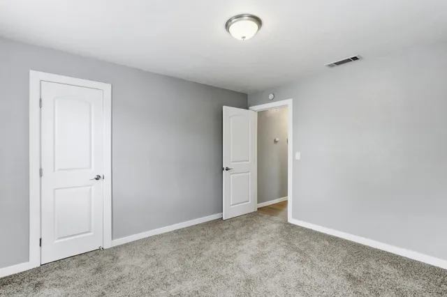 an empty room with closet area