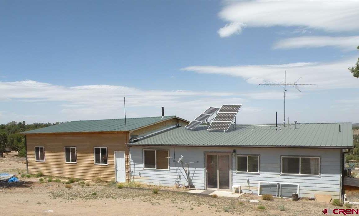 30822 Mailbox Park Road Redvale, CO 81431 - Photo 2 of 32 a front view of a house with a yard