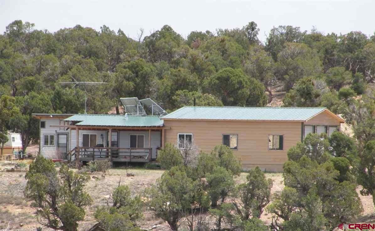 30822 Mailbox Park Road Redvale, CO 81431 - Photo 30 of 32 an aerial view of a house with yard and trees in the background