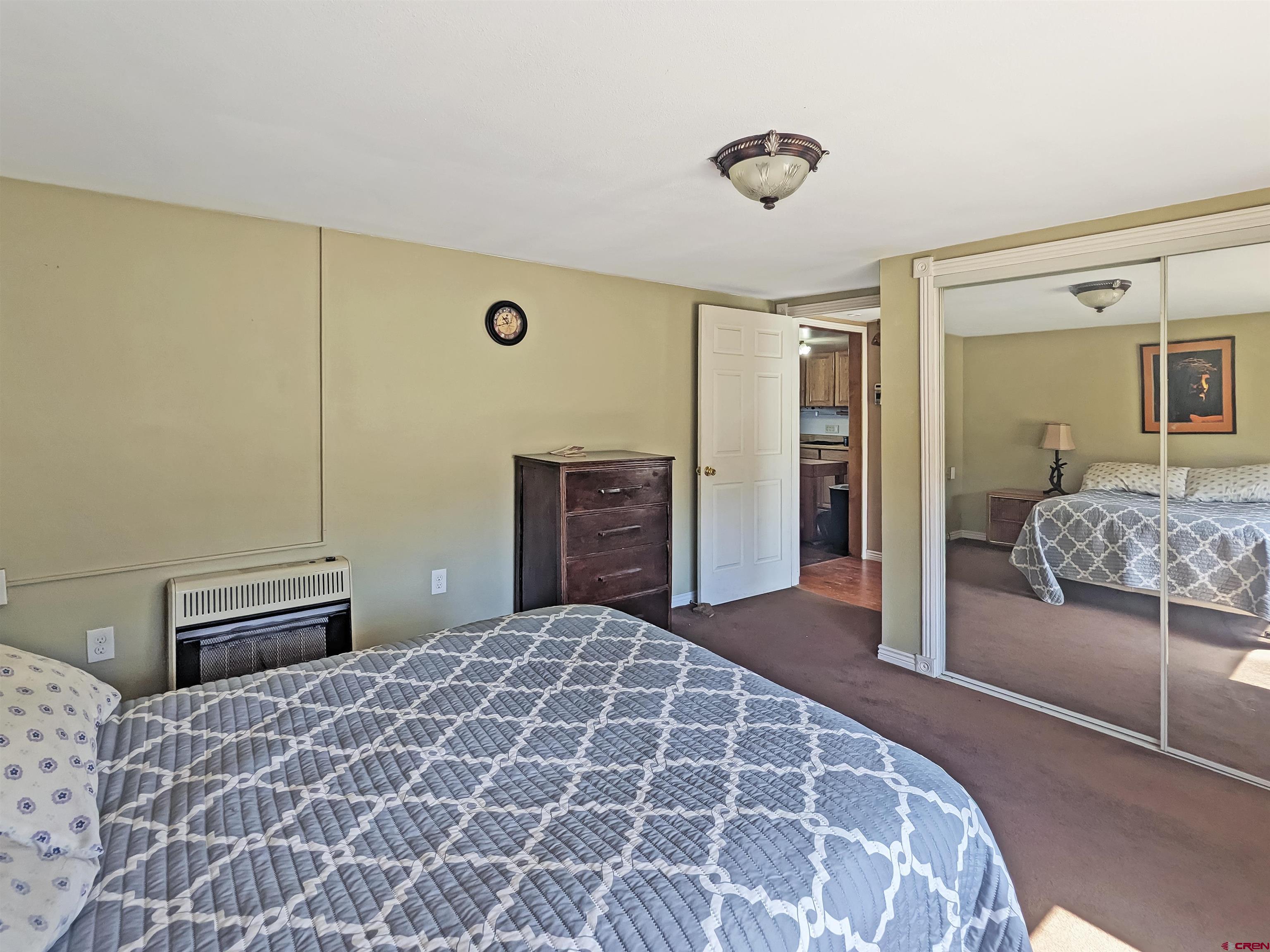 30822 Mailbox Park Road Redvale, CO 81431 - Photo 8 of 32 a bedroom with a large bed and a dresser