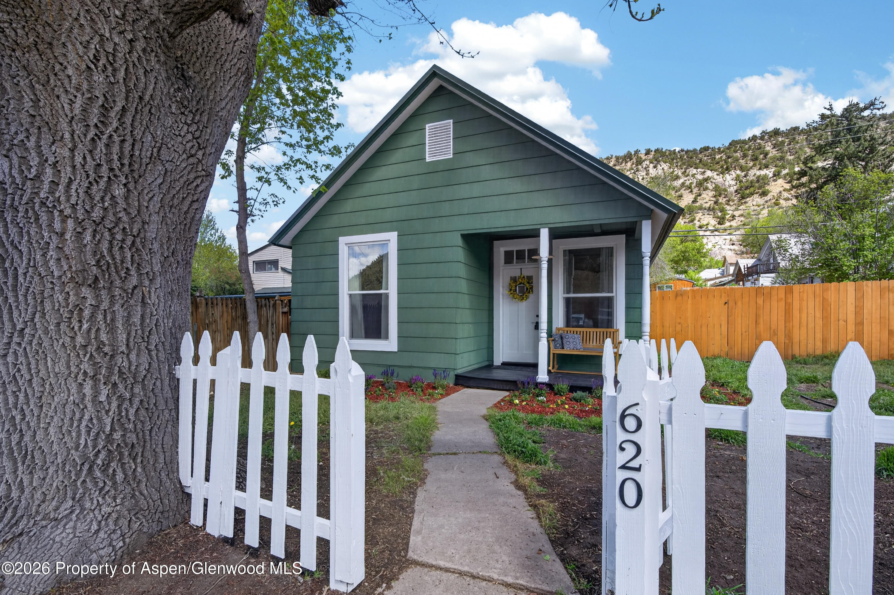 620 West Main Street New Castle, CO 81647 - Photo 1 of 27 a front view of a house with garden