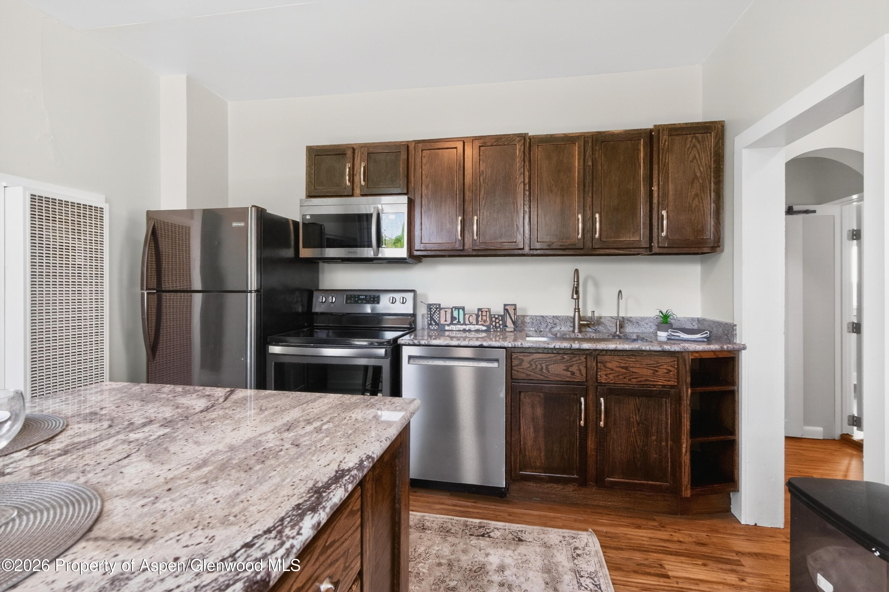620 West Main Street New Castle, CO 81647 - Photo 11 of 27 a kitchen with stainless steel appliances granite countertop a stove refrigerator and a microwave oven
