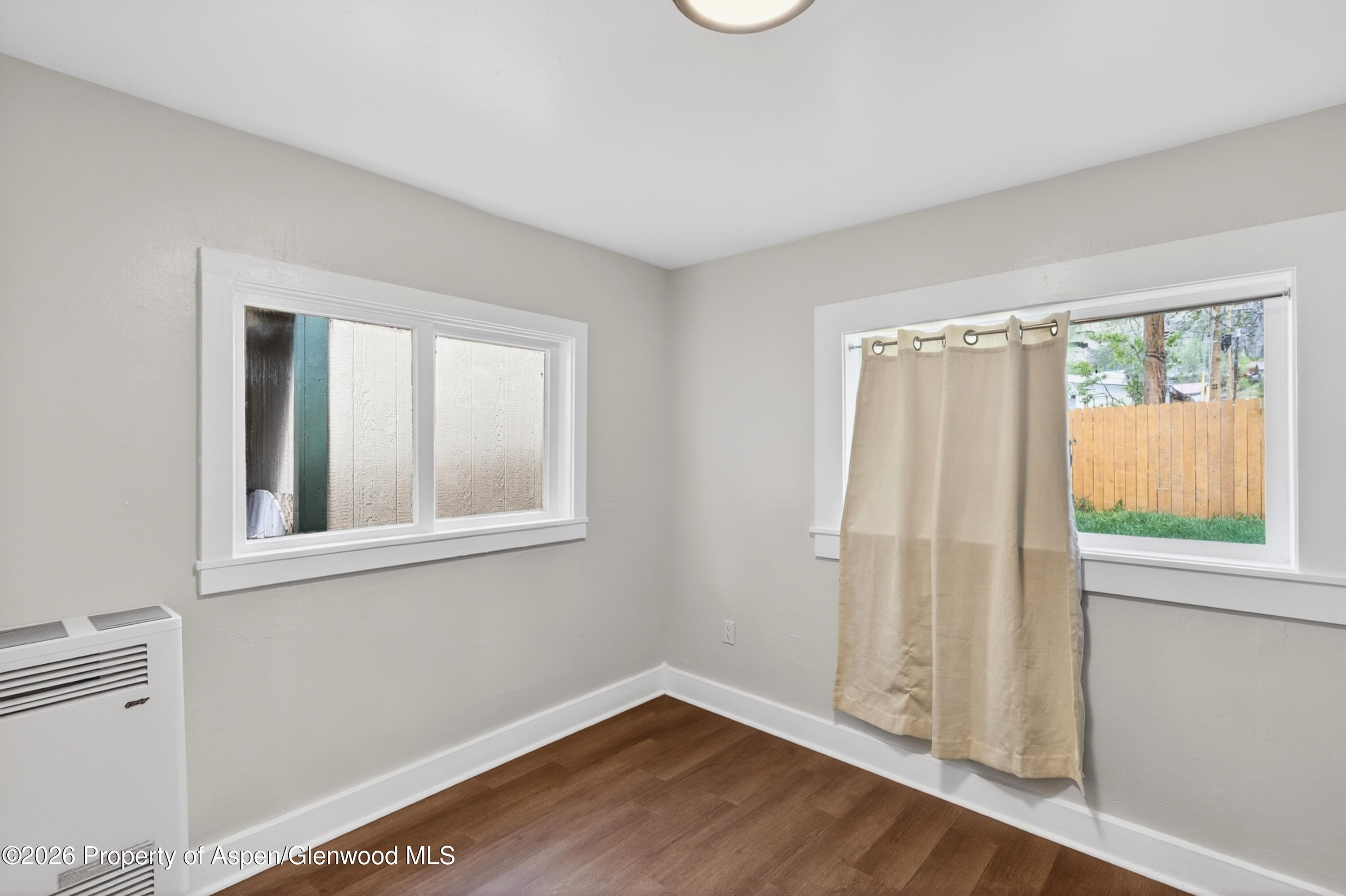 620 West Main Street New Castle, CO 81647 - Photo 21 of 27 an empty room with wooden floor and windows