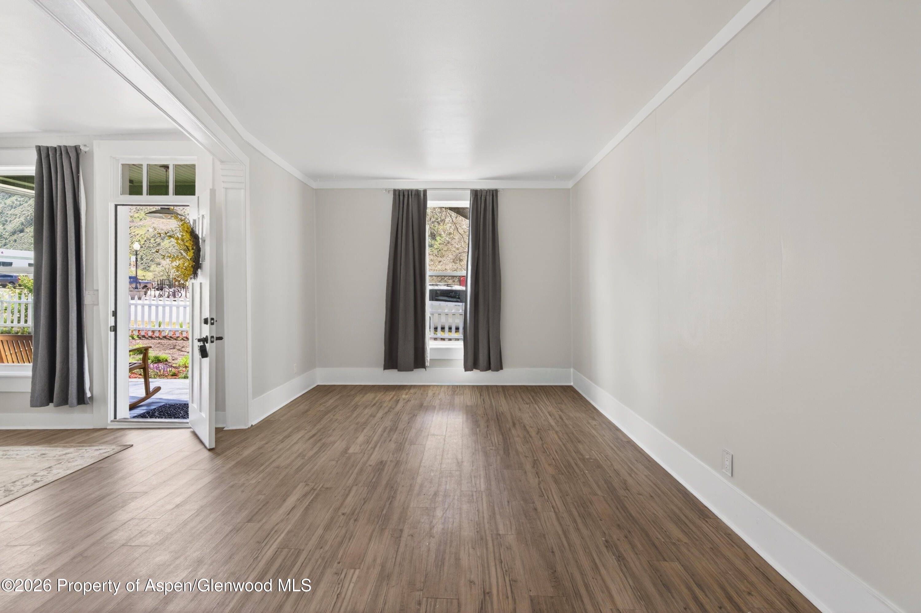 620 West Main Street New Castle, CO 81647 - Photo 6 of 27 an empty room with window and wooden floor