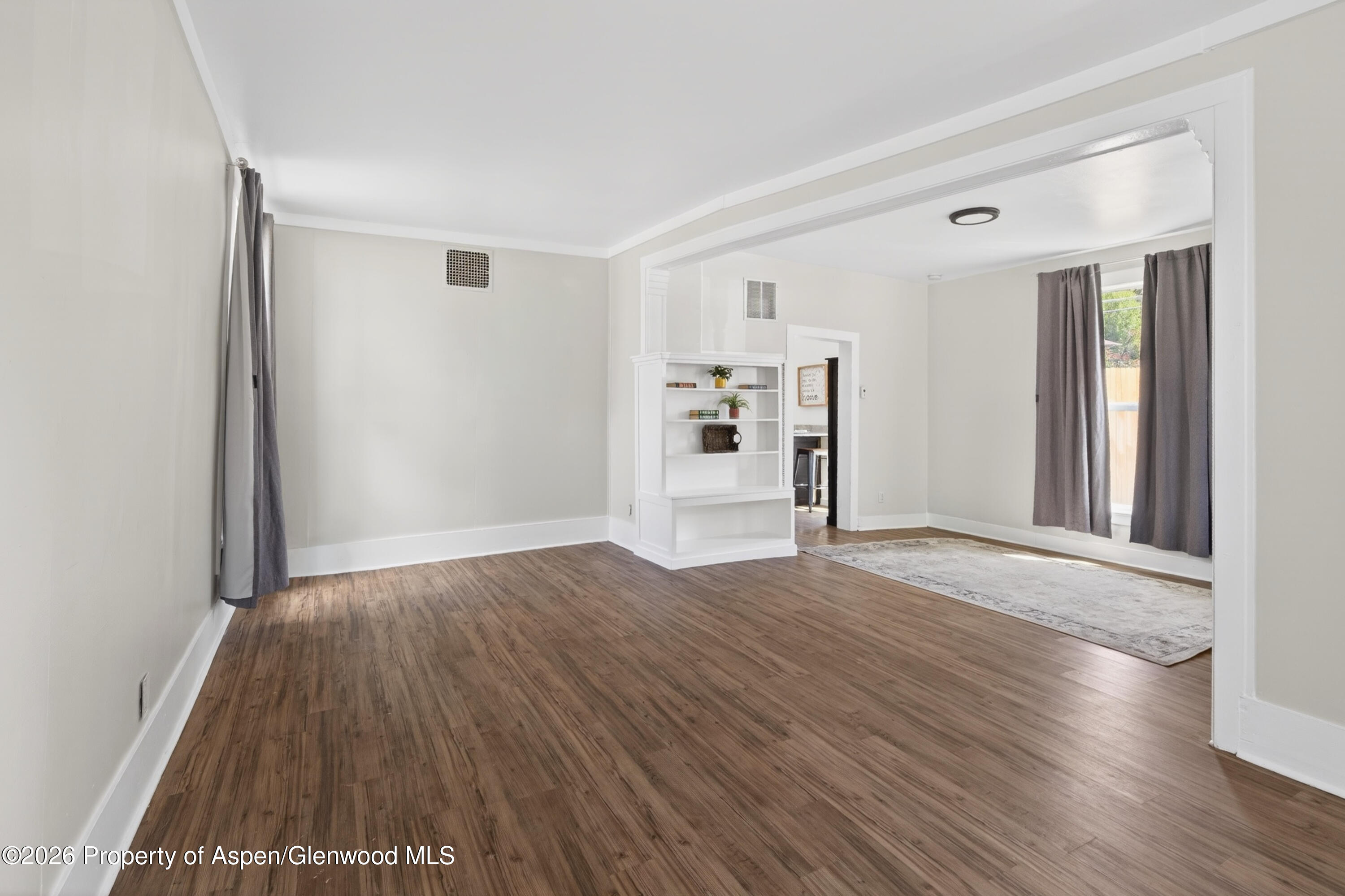 620 West Main Street New Castle, CO 81647 - Photo 7 of 27 wooden floor in an empty room with a window