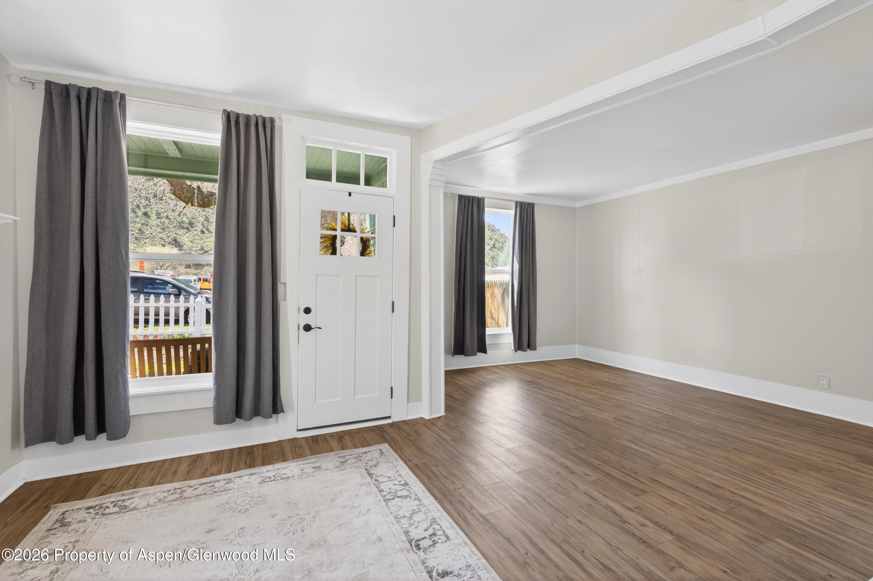 620 West Main Street New Castle, CO 81647 - Photo 9 of 27 an empty room with wooden floor and windows