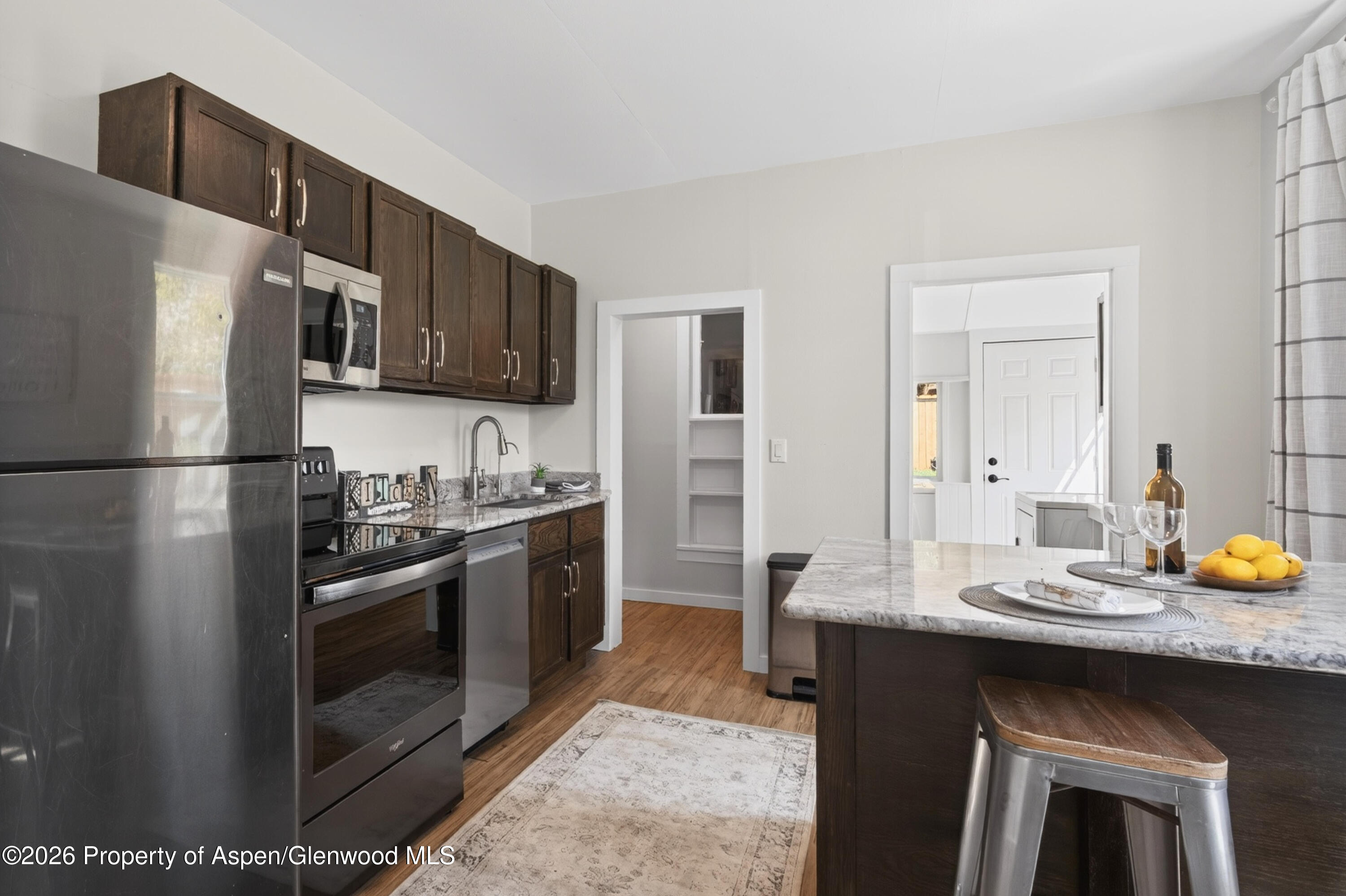 620 West Main Street New Castle, CO 81647 - Photo 10 of 27 a kitchen with stainless steel appliances a sink stove and refrigerator