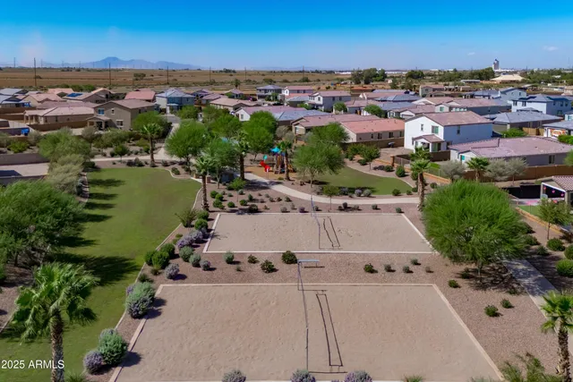 an aerial view of a city with lots of residential buildings ocean and mountain view in back