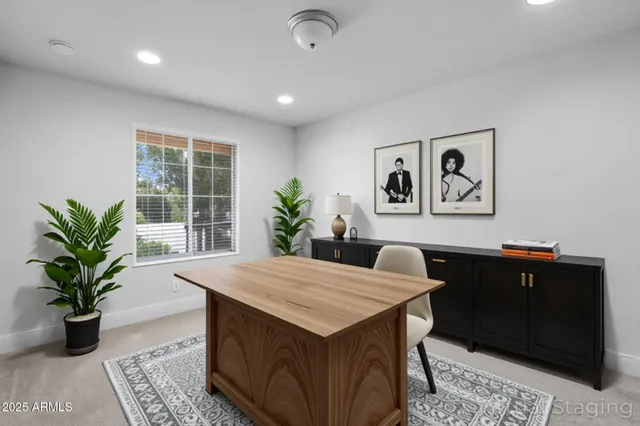 a view of a workspace with furniture and window