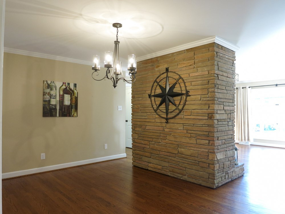 105 Dartmouth Road Raleigh, NC 27609 - Photo 5 of 25 Dining Rm features a stone wall & black iron light fixture, and it is open to the Kitchen. Dining Room
