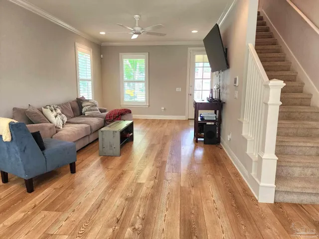 a living room with furniture and a wooden floor