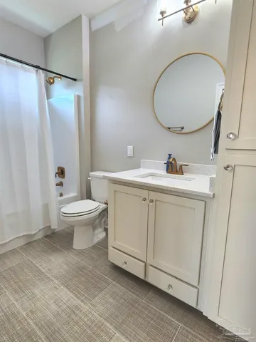 a bathroom with a sink toilet and a mirror