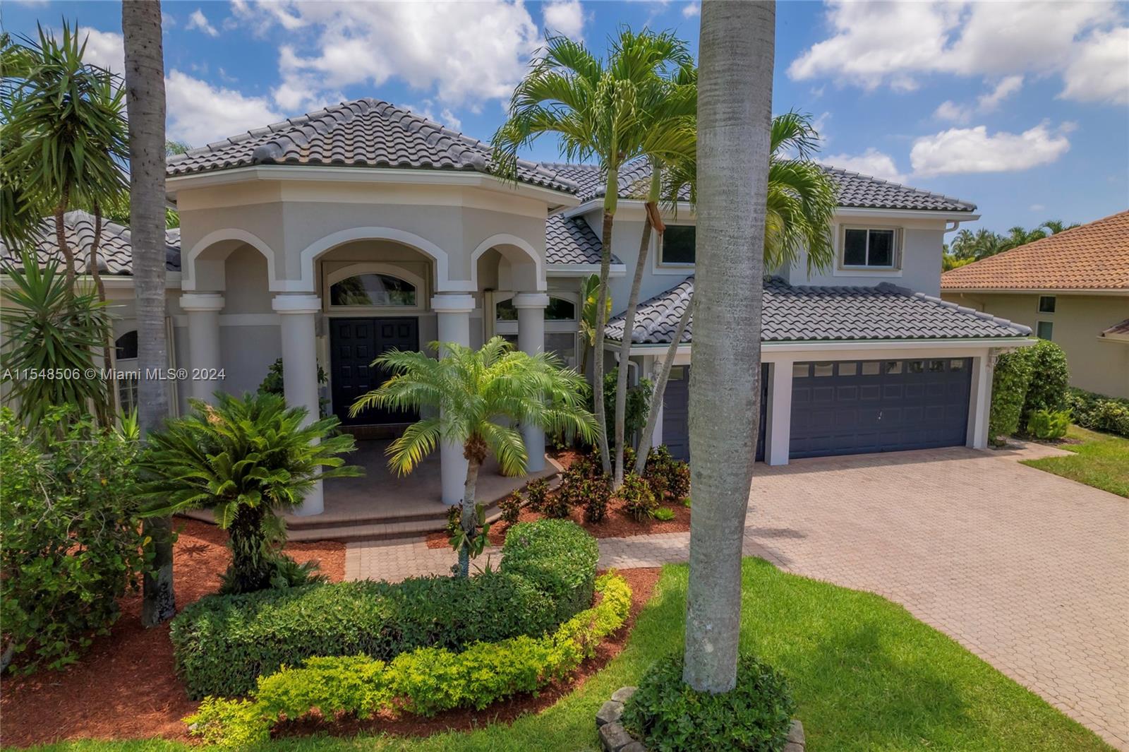 10849-10849 Bal Harbor Drive Boca Raton, FL 33498 - Photo 1 of 72 a front view of a house with a yard and garage