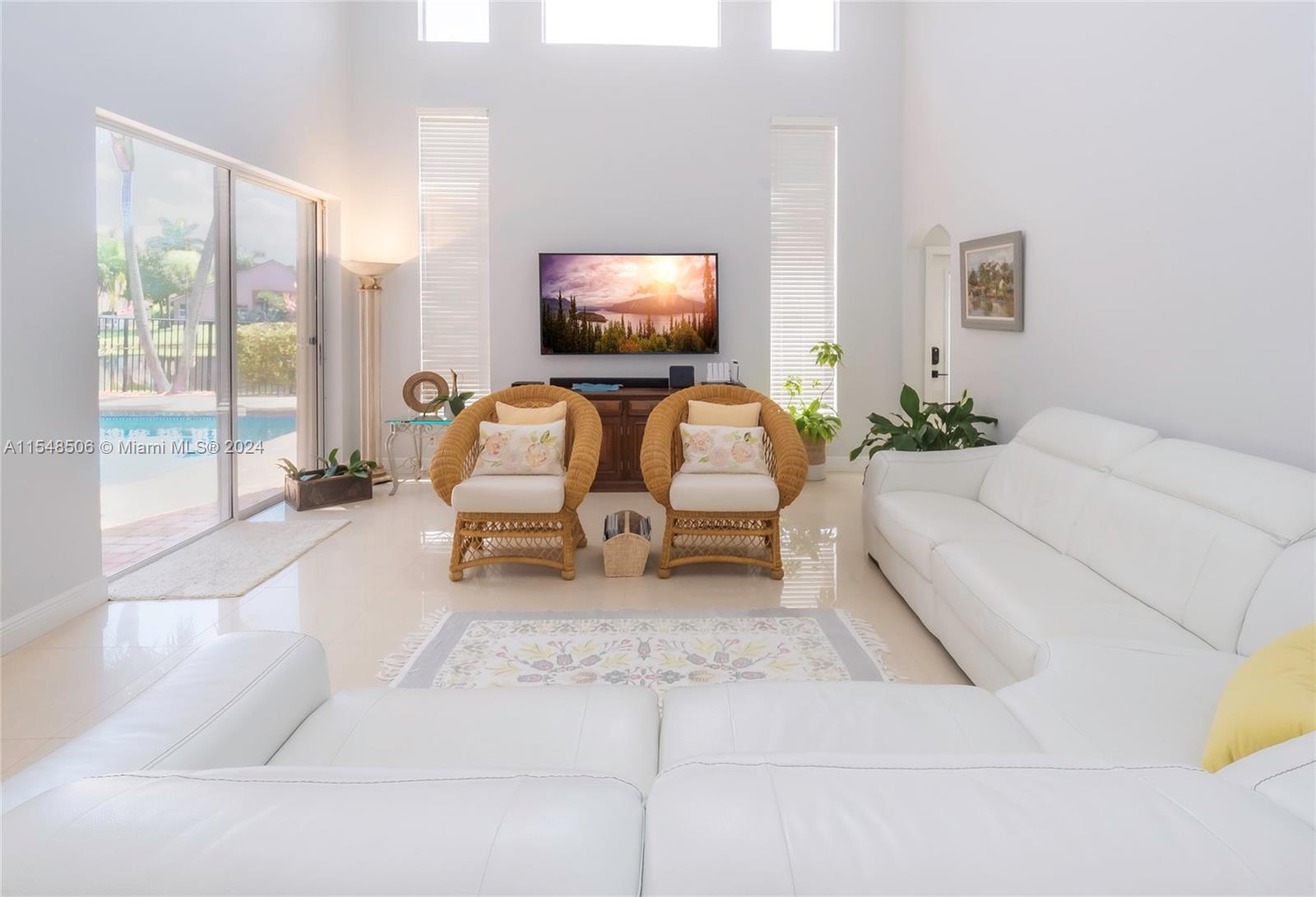 10849-10849 Bal Harbor Drive Boca Raton, FL 33498 - Photo 16 of 72 a living room with furniture and a flat screen tv