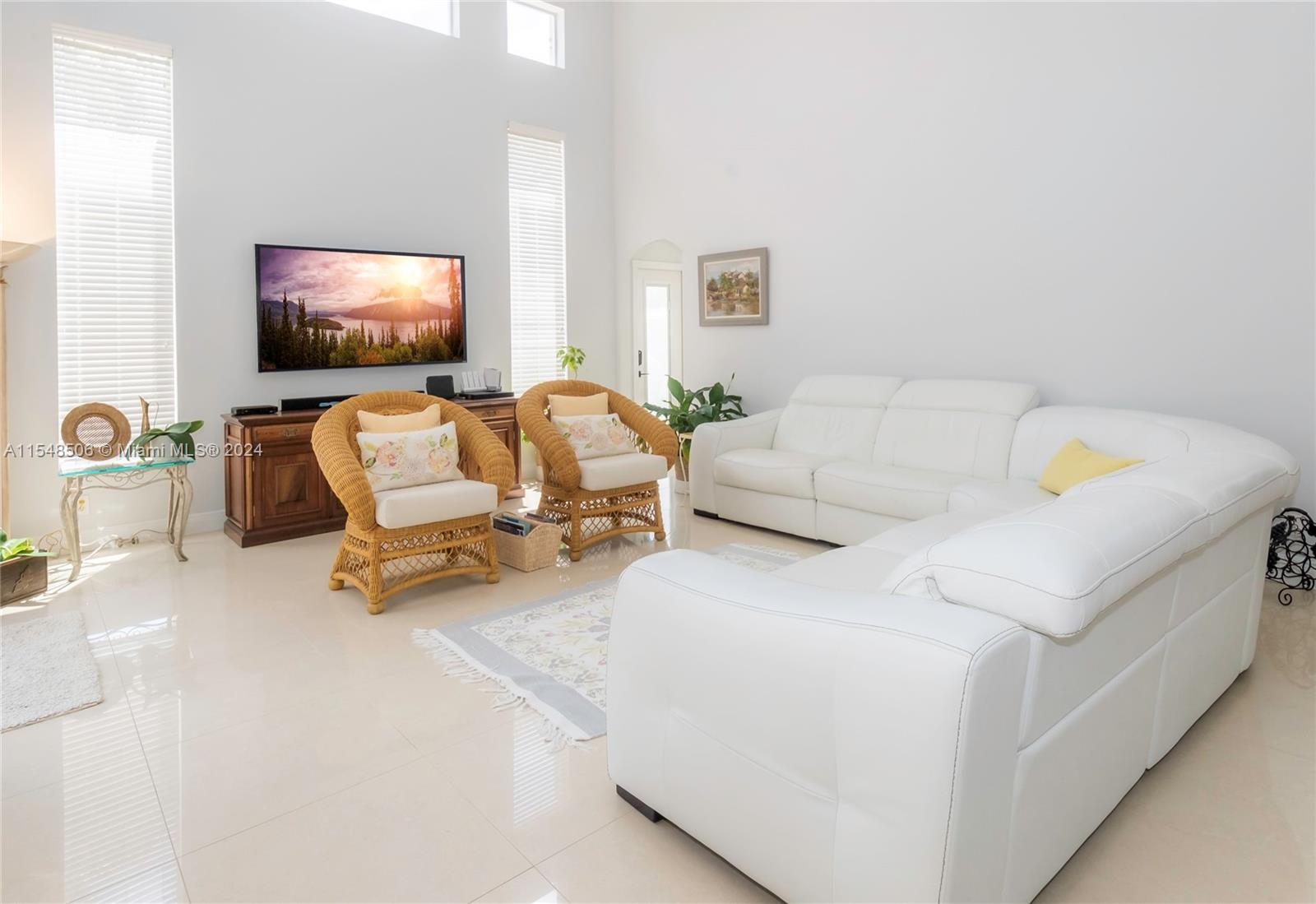 10849-10849 Bal Harbor Drive Boca Raton, FL 33498 - Photo 17 of 72 a living room with furniture and a flat screen tv