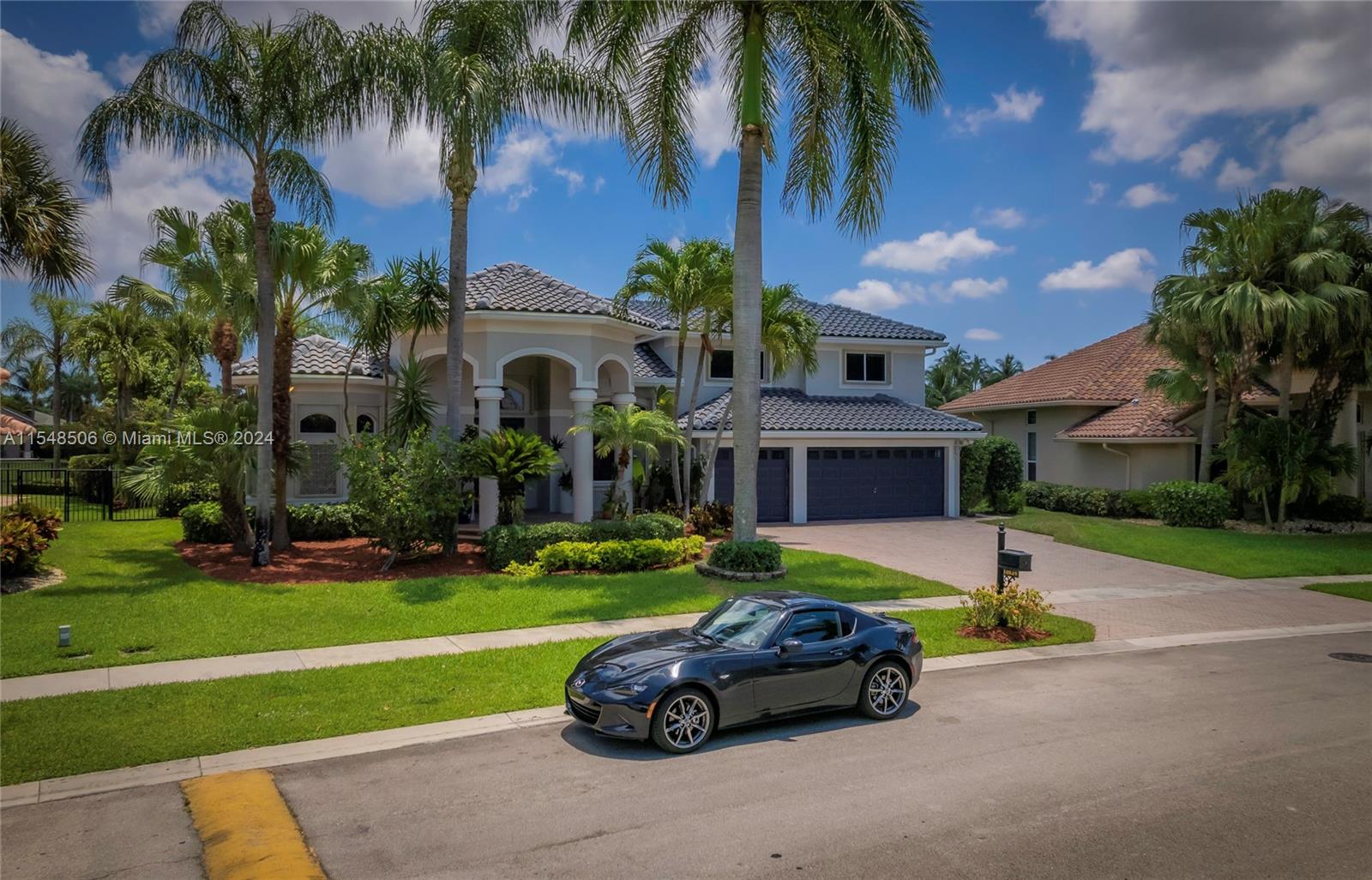 10849-10849 Bal Harbor Drive Boca Raton, FL 33498 - Photo 2 of 72 a car parked in front of a house with a yard