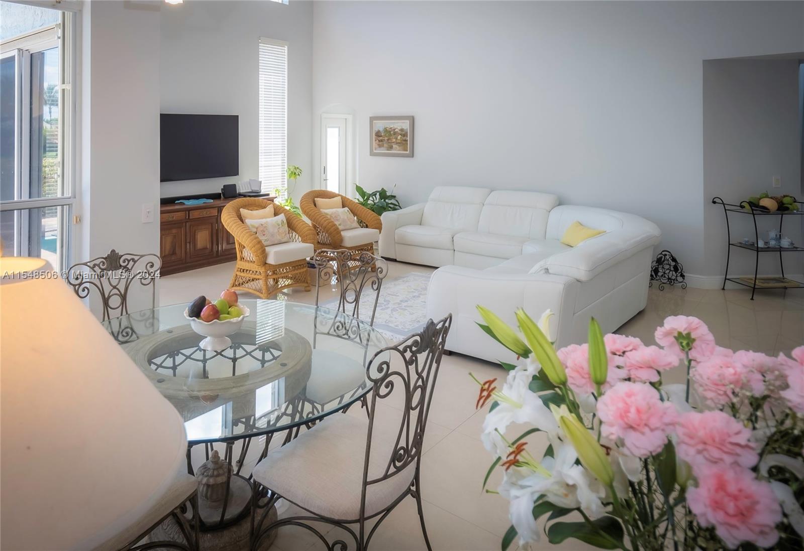 10849-10849 Bal Harbor Drive Boca Raton, FL 33498 - Photo 23 of 72 a living room with furniture and flowers