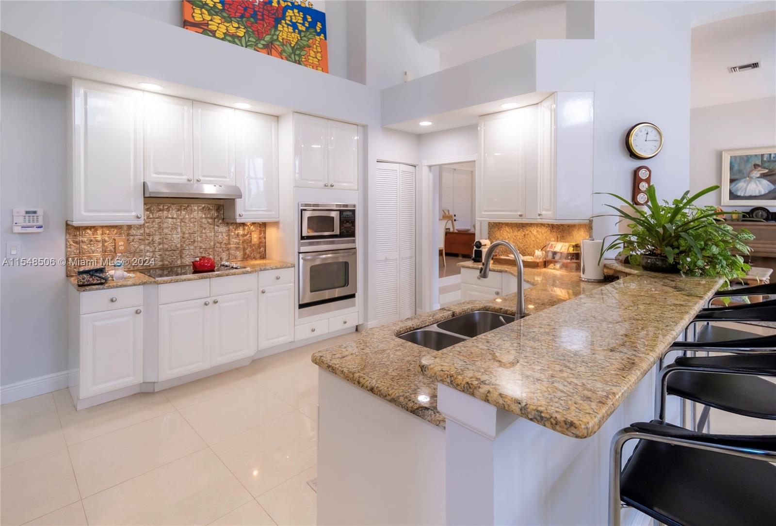 10849-10849 Bal Harbor Drive Boca Raton, FL 33498 - Photo 25 of 72 a kitchen with stainless steel appliances granite countertop a sink and a refrigerator