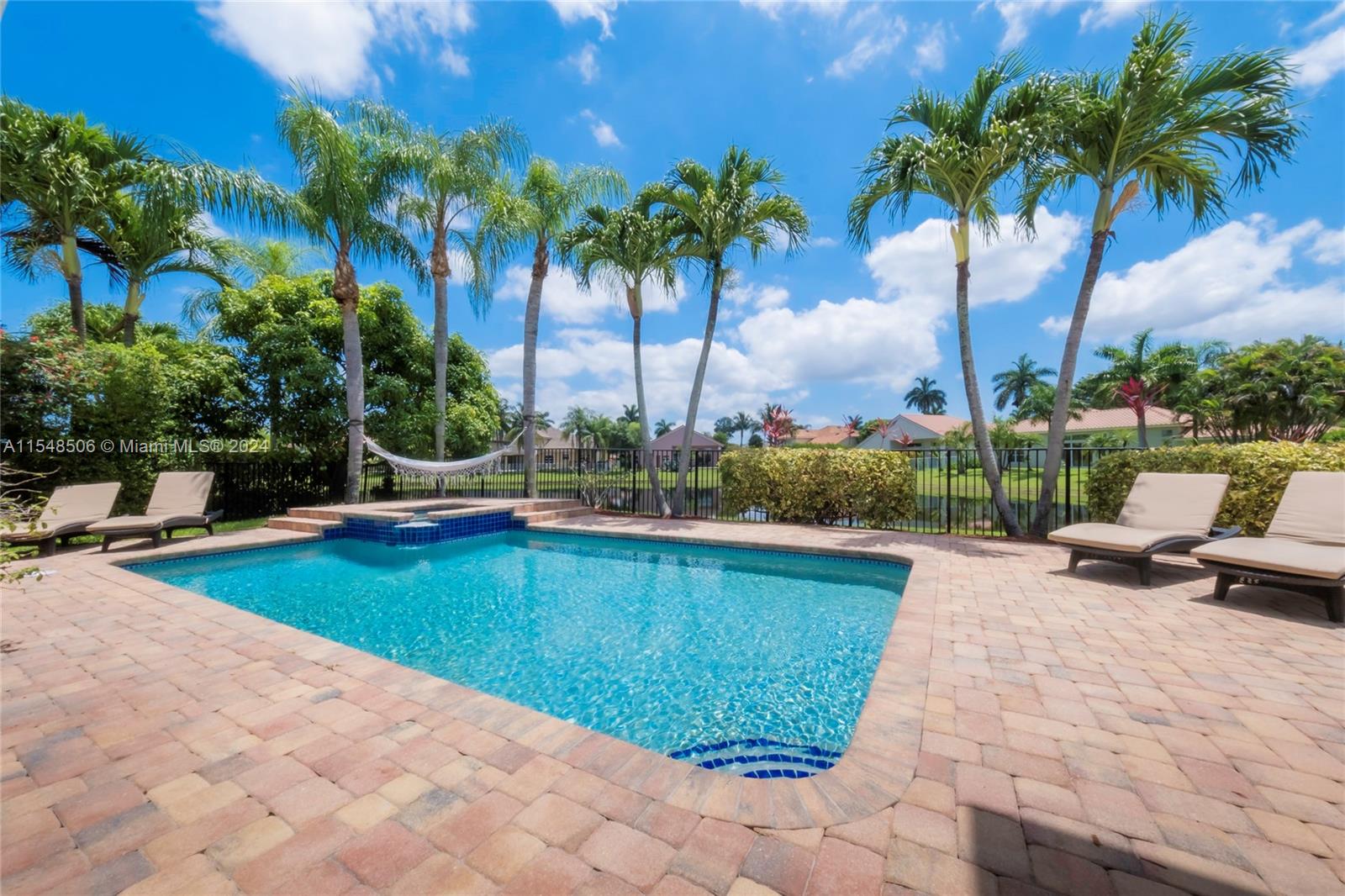 10849-10849 Bal Harbor Drive Boca Raton, FL 33498 - Photo 30 of 72 a view of swimming pool with a lounge chair and palm trees