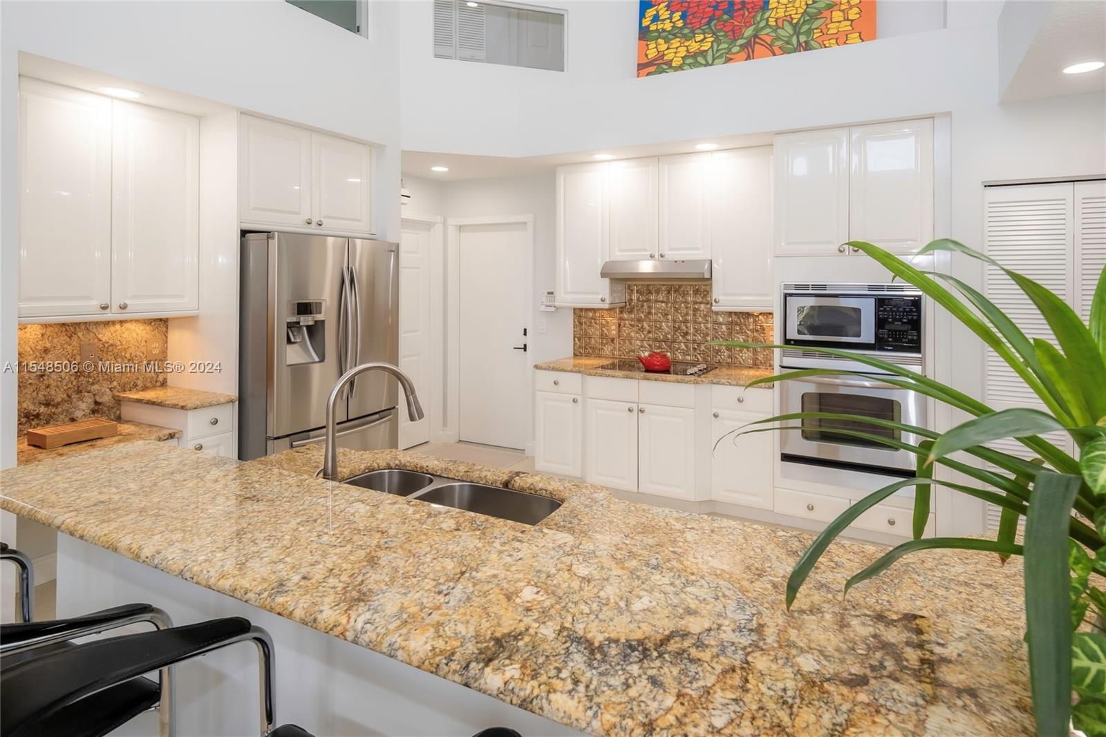 10849-10849 Bal Harbor Drive Boca Raton, FL 33498 - Photo 37 of 72 a kitchen with stainless steel appliances granite countertop a sink stove and refrigerator