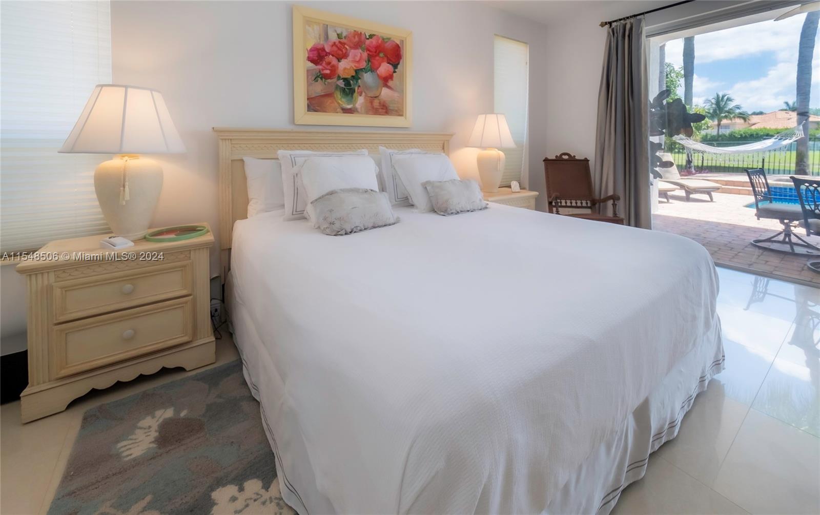 10849-10849 Bal Harbor Drive Boca Raton, FL 33498 - Photo 38 of 72 a bedroom with a bed and a painting on the wall