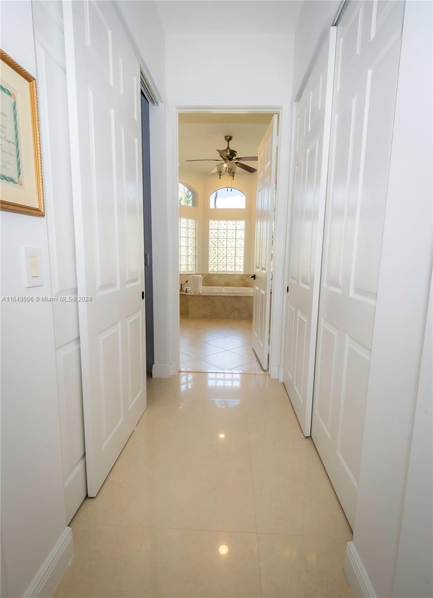 10849-10849 Bal Harbor Drive Boca Raton, FL 33498 - Photo 39 of 72 a view of a hallway with a window and a livingroom