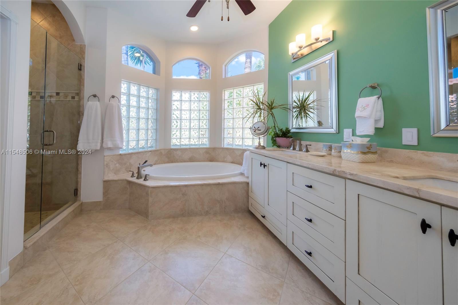 10849-10849 Bal Harbor Drive Boca Raton, FL 33498 - Photo 41 of 72 a bathroom with a granite countertop tub sink and mirror