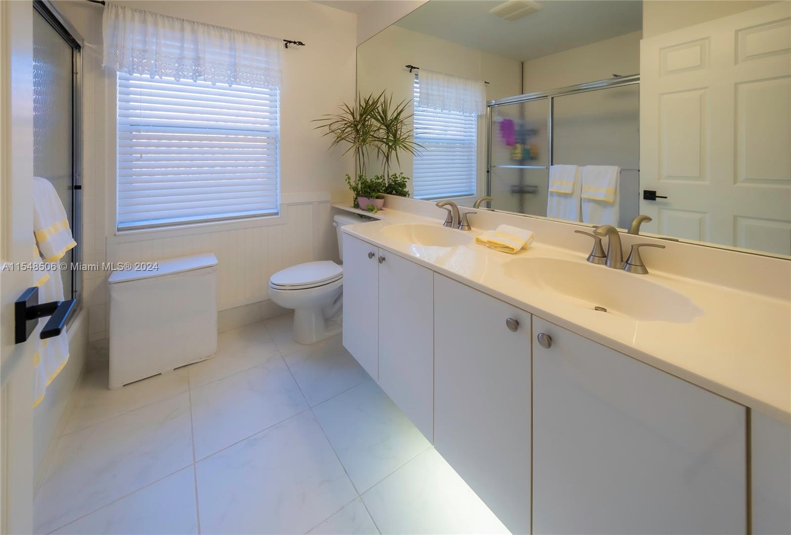 10849-10849 Bal Harbor Drive Boca Raton, FL 33498 - Photo 44 of 72 a bathroom with a granite countertop sink toilet and shower
