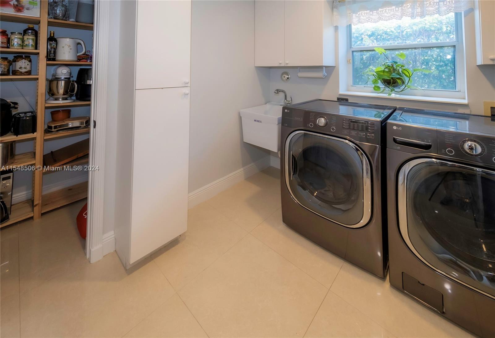 10849-10849 Bal Harbor Drive Boca Raton, FL 33498 - Photo 46 of 72 a utility room with stainless steel appliances wooden cabinet and a window