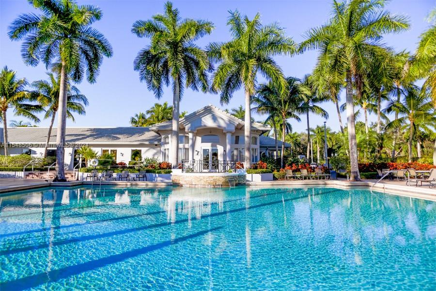 10849-10849 Bal Harbor Drive Boca Raton, FL 33498 - Photo 47 of 72 a view of a swimming pool with a table and chairs