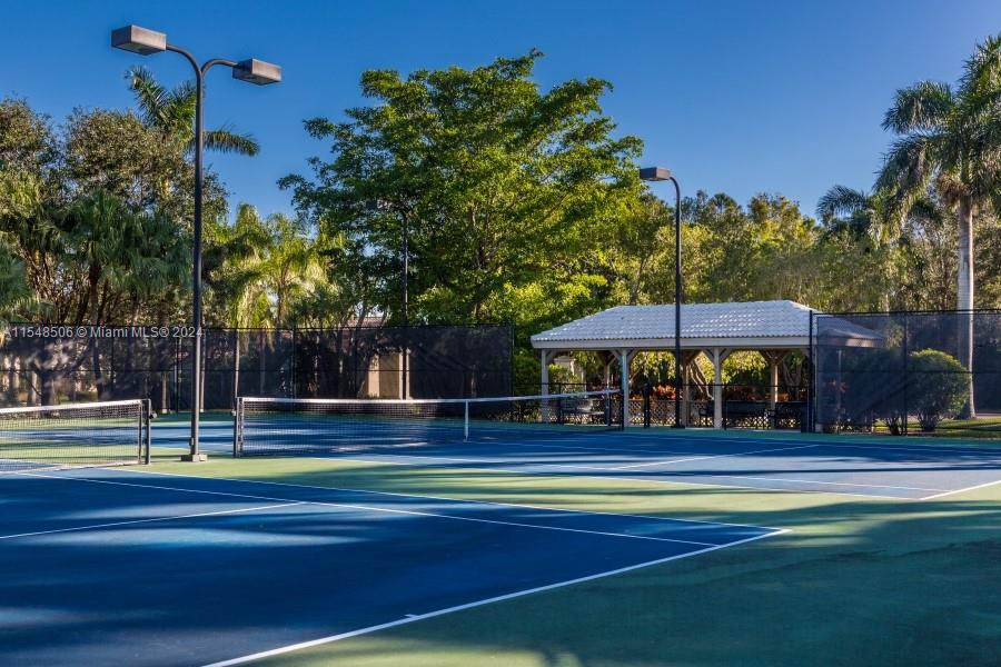 10849-10849 Bal Harbor Drive Boca Raton, FL 33498 - Photo 50 of 72 a view of a tennis ground with large trees