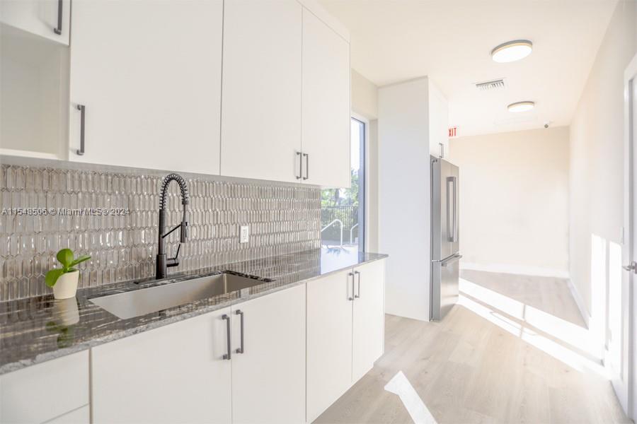 10849-10849 Bal Harbor Drive Boca Raton, FL 33498 - Photo 60 of 72 a kitchen with stainless steel appliances granite countertop a sink and a granite counter tops