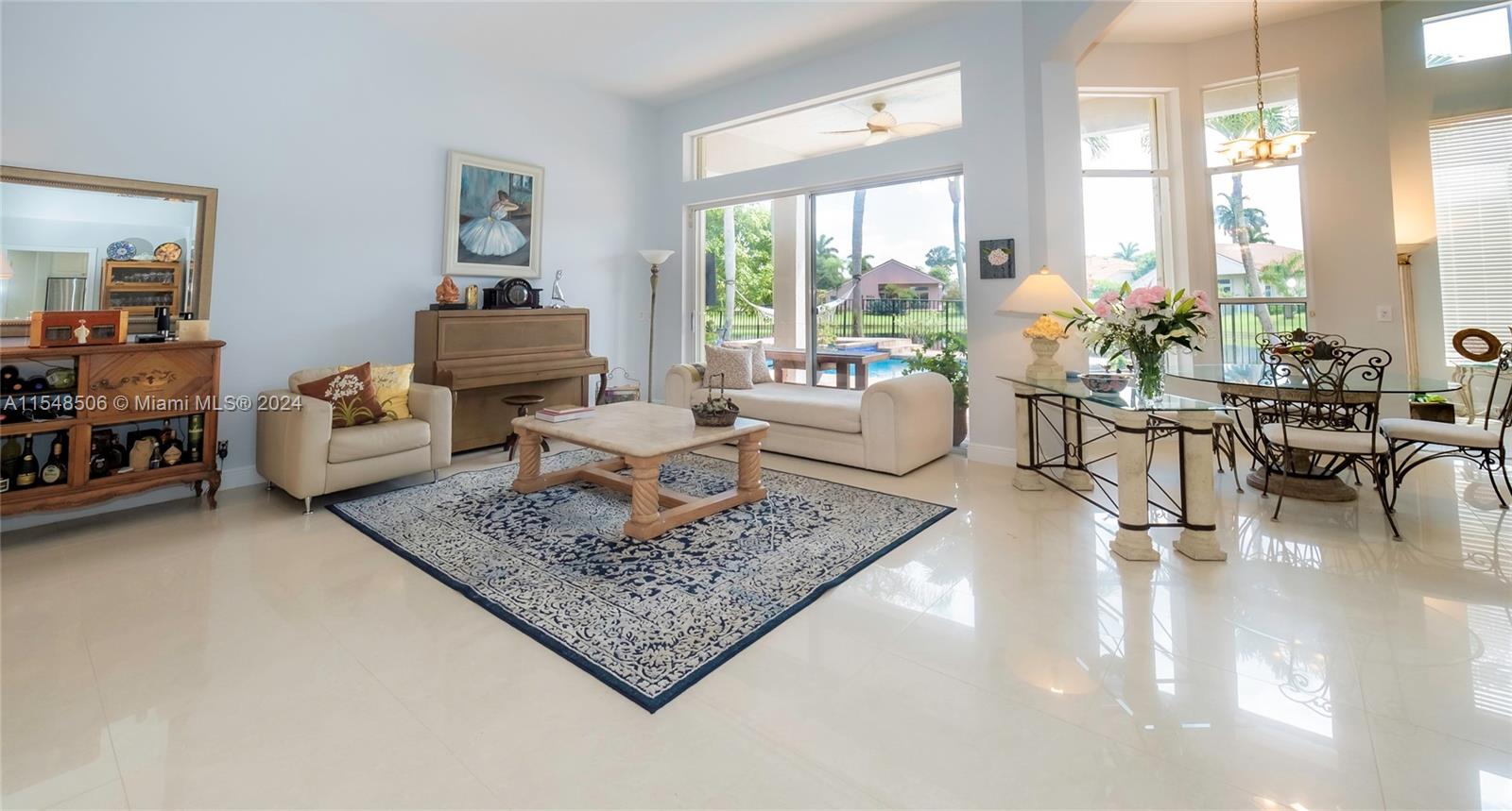 10849-10849 Bal Harbor Drive Boca Raton, FL 33498 - Photo 9 of 72 a living room with furniture and a large window