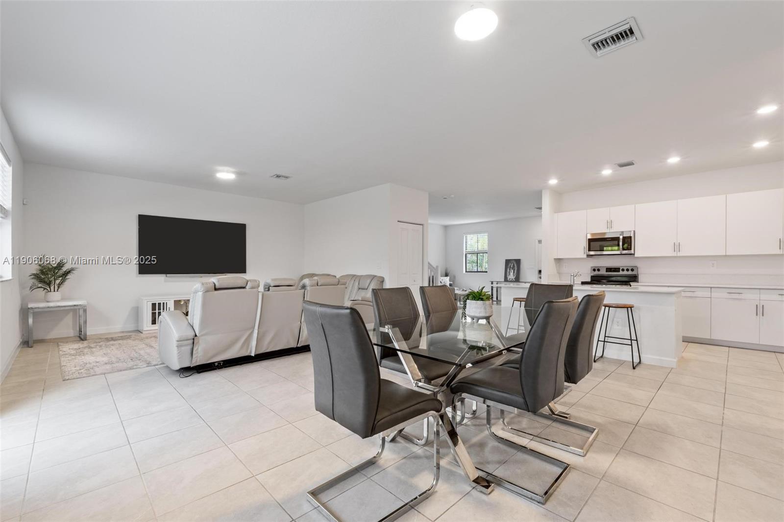 11903 Southwest 241st Street Homestead, FL 33032 - Photo 14 of 56 a living room with furniture and a flat screen tv