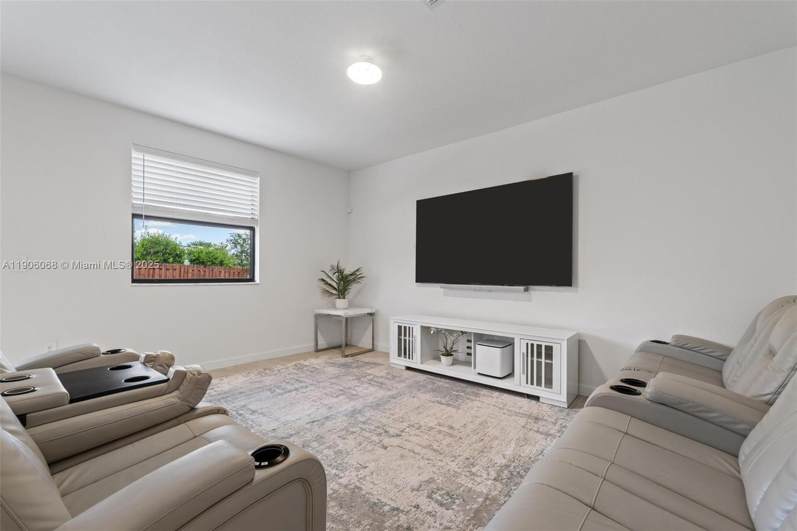 11903 Southwest 241st Street Homestead, FL 33032 - Photo 15 of 56 a living room with furniture and a flat screen tv