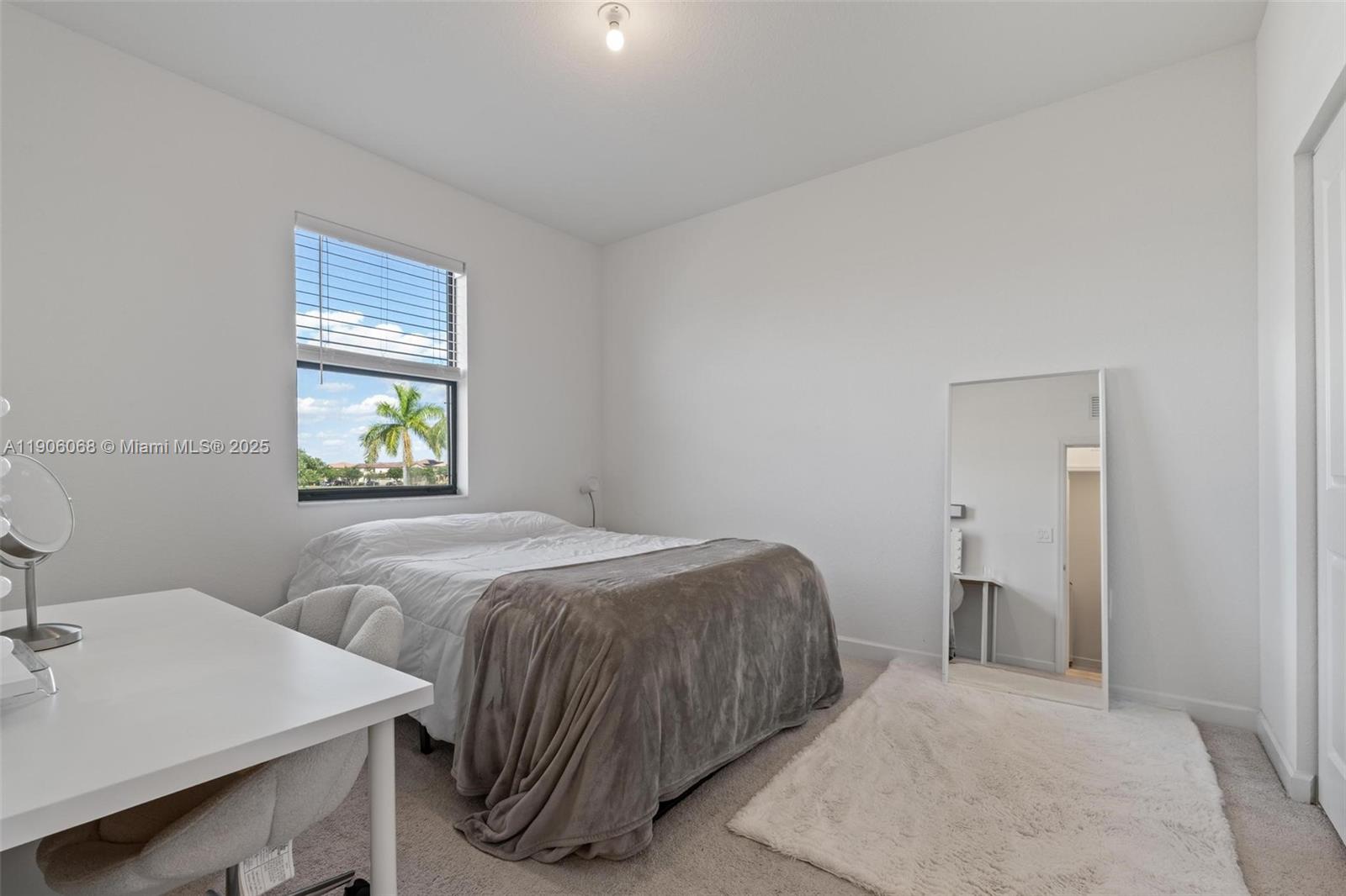 11903 Southwest 241st Street Homestead, FL 33032 - Photo 41 of 56 a bedroom with two beds and a lamp on table