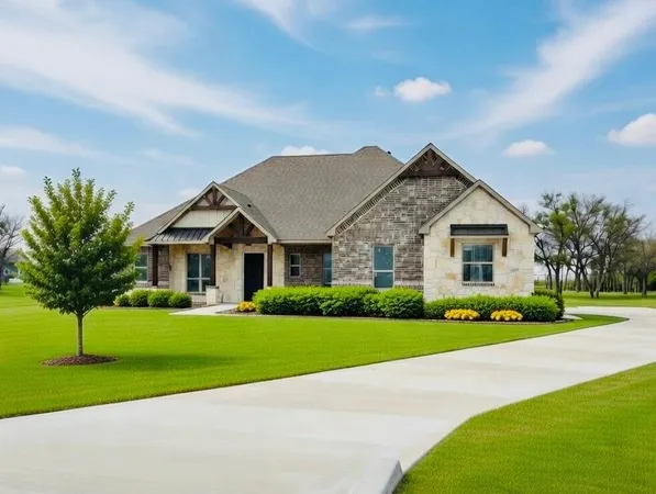 a view of house that has a yard