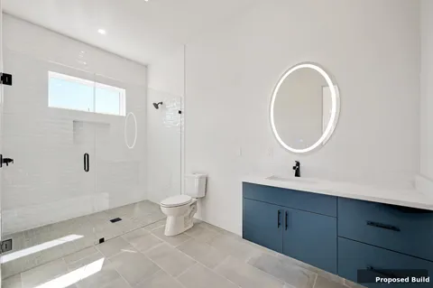 a bathroom with a toilet sink a mirror and vanity