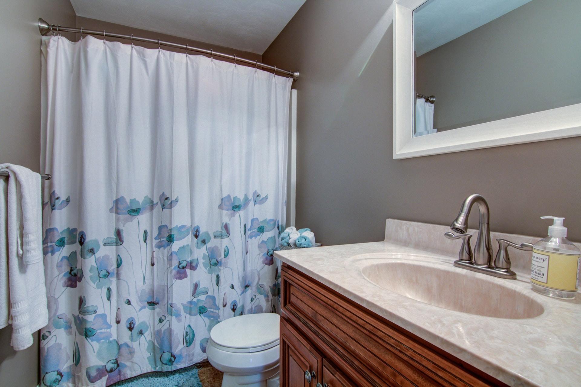 1847 Redwood Road Southeast Roanoke, VA 24014 - Photo 15 of 33 a bathroom with a granite countertop sink a toilet and a mirror