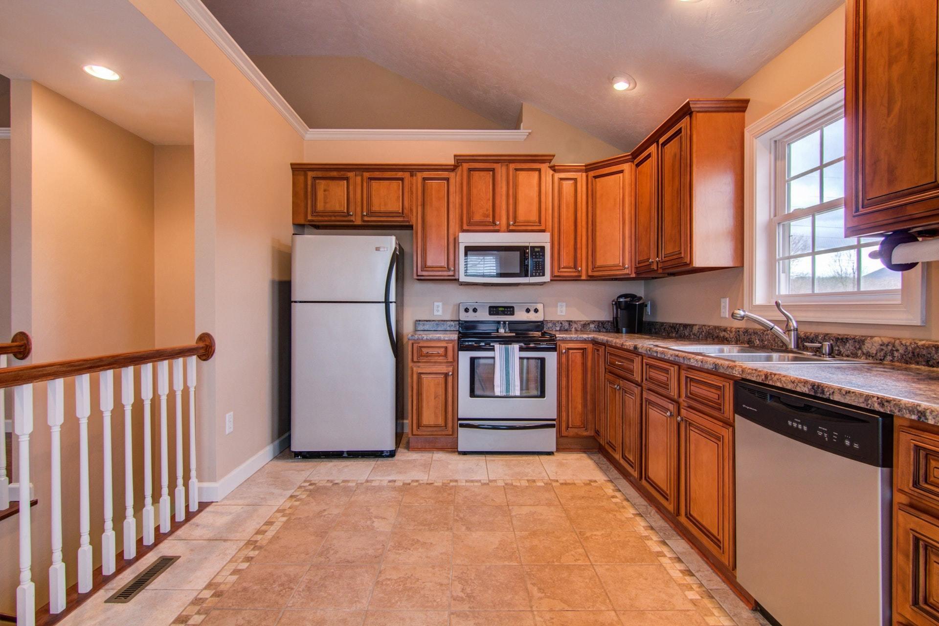 1847 Redwood Road Southeast Roanoke, VA 24014 - Photo 8 of 33 a kitchen with stainless steel appliances granite countertop a refrigerator a sink dishwasher a stove with wooden cabinets and a large window