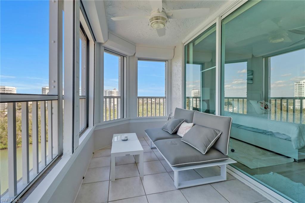 25 Bluebill Avenue, Unit A906 Naples, FL 34108 - Photo 11 of 40 a living room with furniture and a large window