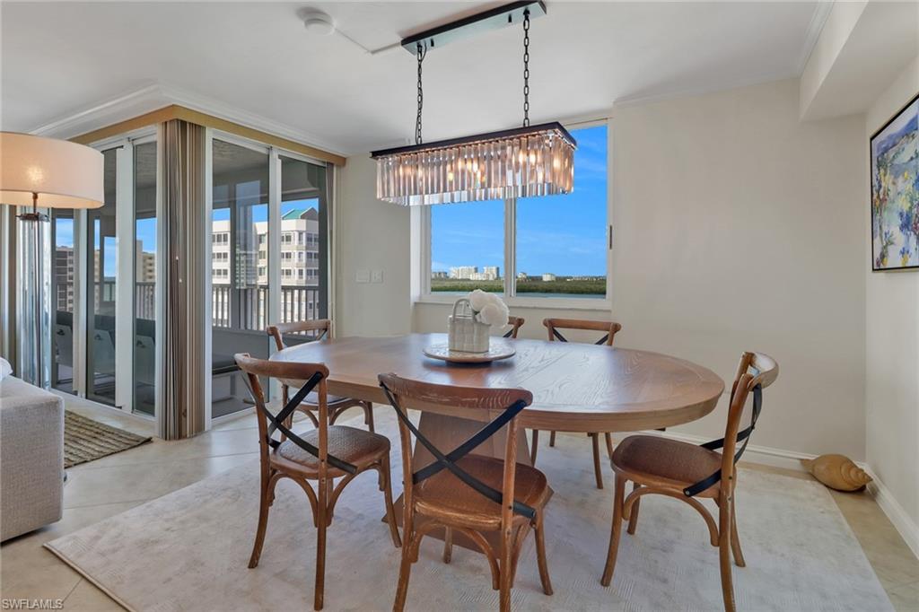 25 Bluebill Avenue, Unit A906 Naples, FL 34108 - Photo 12 of 40 a view of a dining room with furniture and chandelier