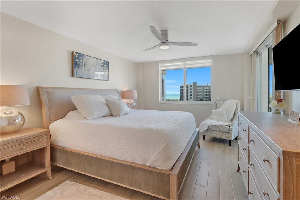 25 Bluebill Avenue, Unit A906 Naples, FL 34108 - Photo 20 of 40 a bedroom with a bed and a flat screen tv