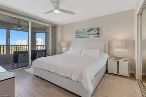 a bedroom with a large bed and a flat screen tv